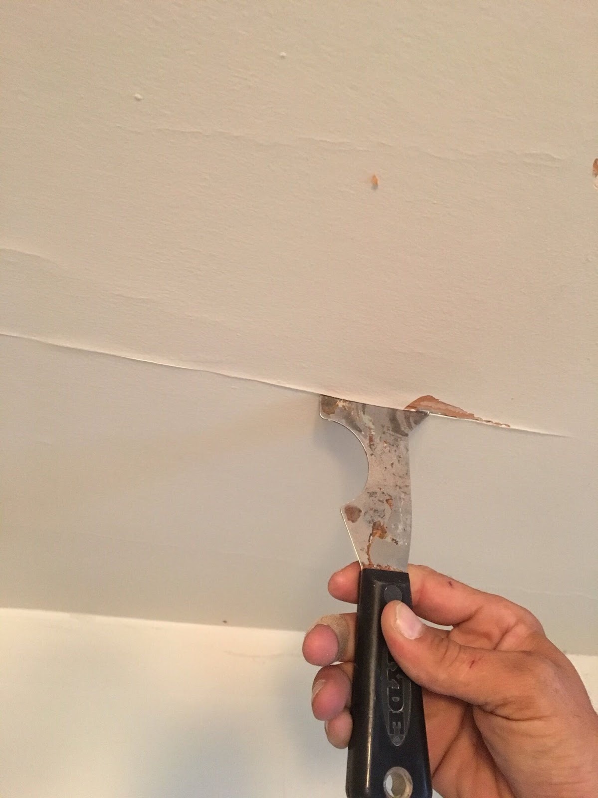 Ceiling seam being repaired and skimmed before painting